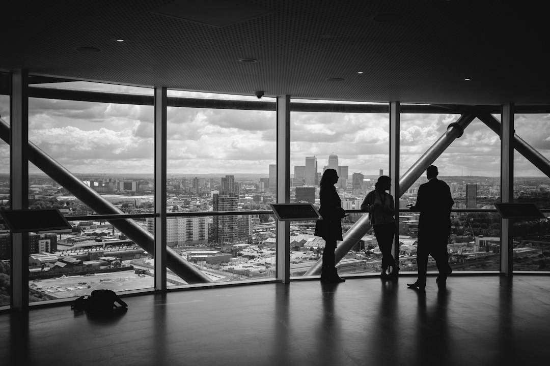 Independent travel agency founder overlooking city skyline planning business expansion
